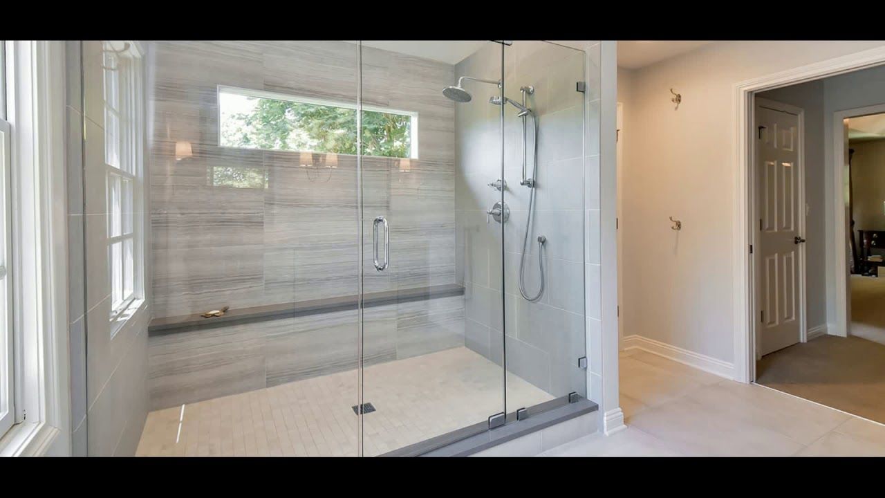 A bathroom with a walk in shower and a window.