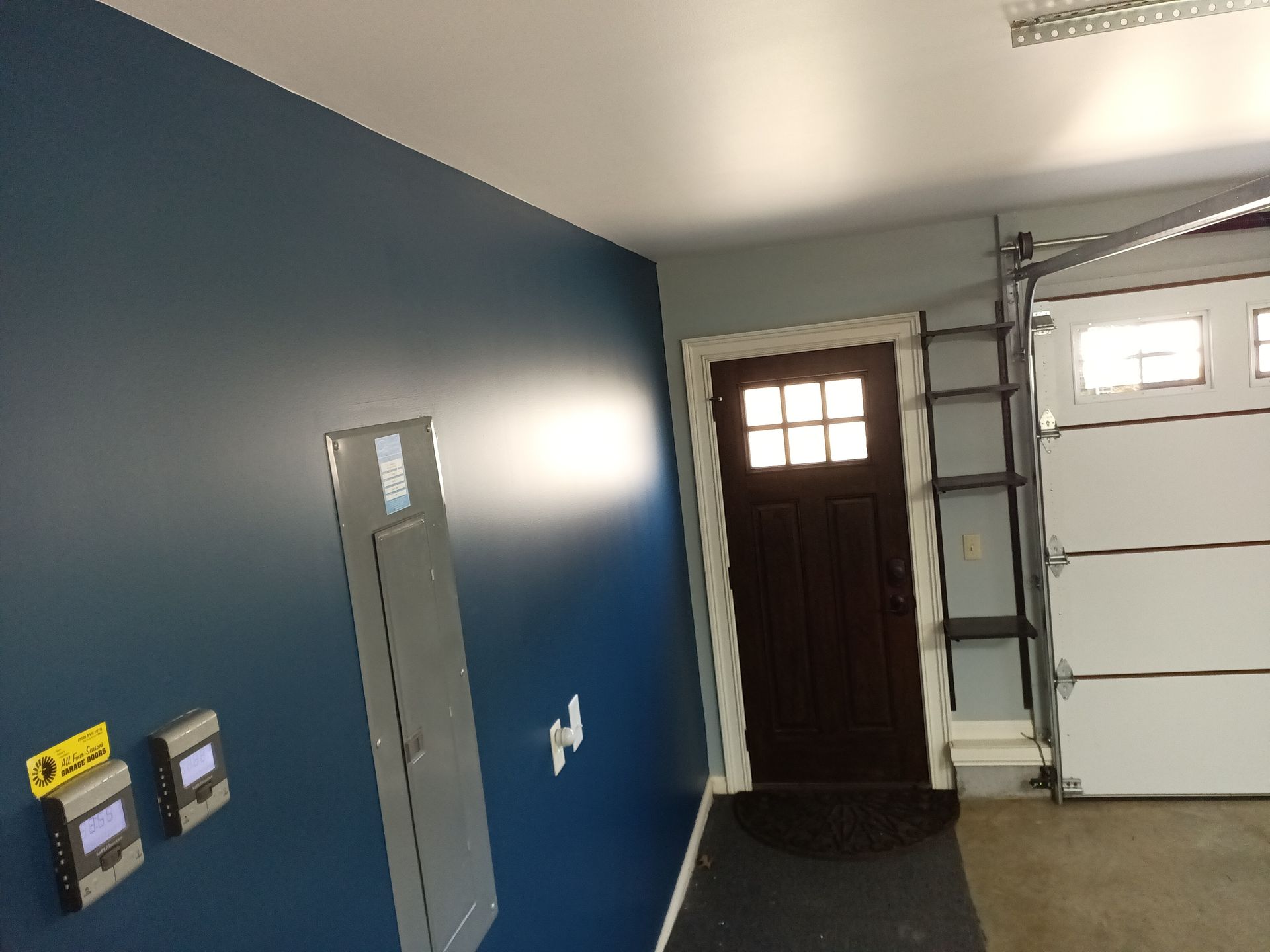 Interior garage wall with fresh residential painting and epoxy finish floor