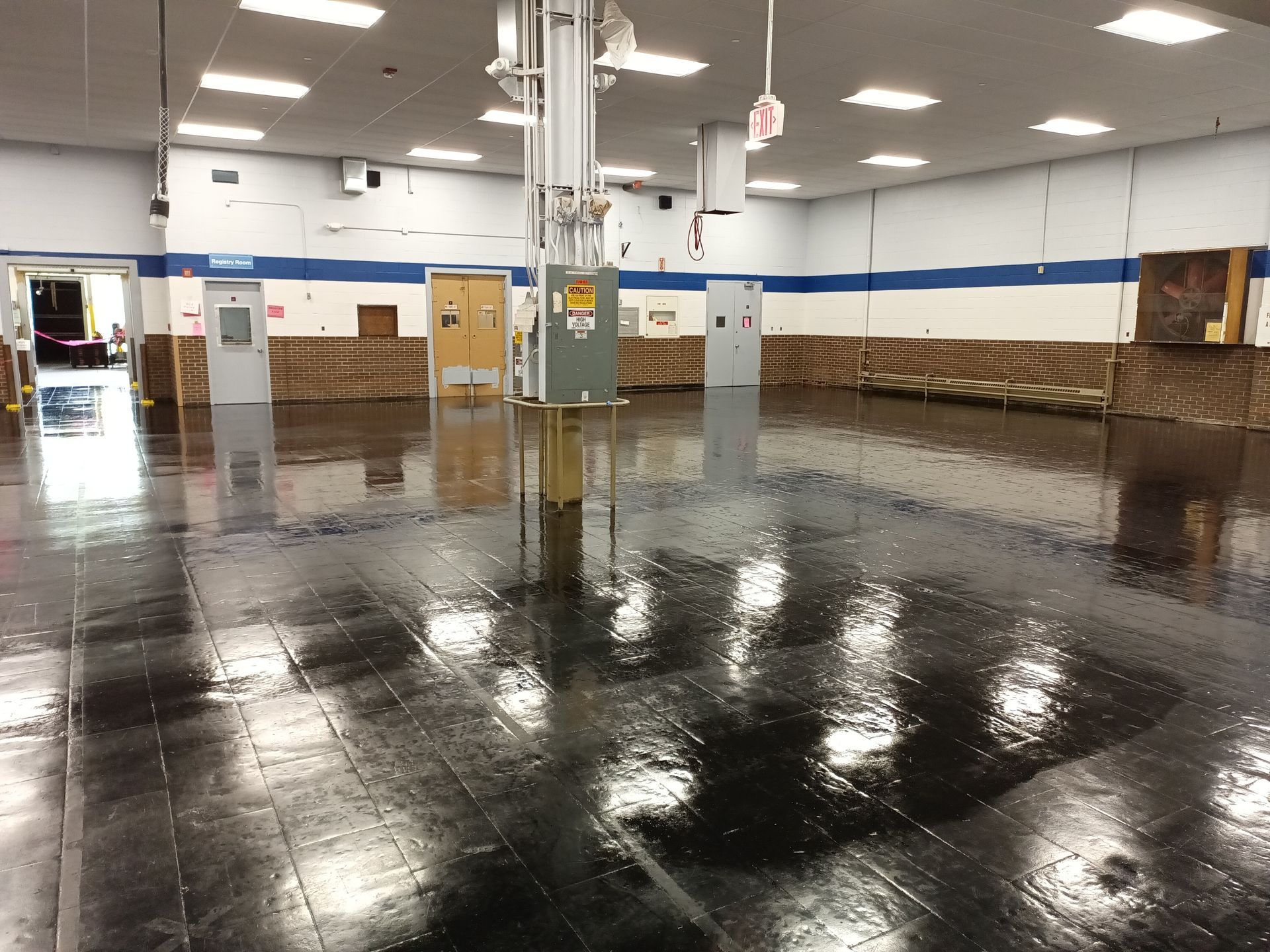 Glossy black industrial floor coating in large commercial facility