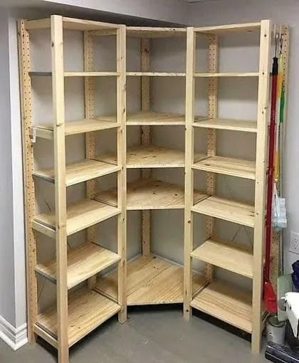 Wooden corner shelving unit against a wall, used for storage.
