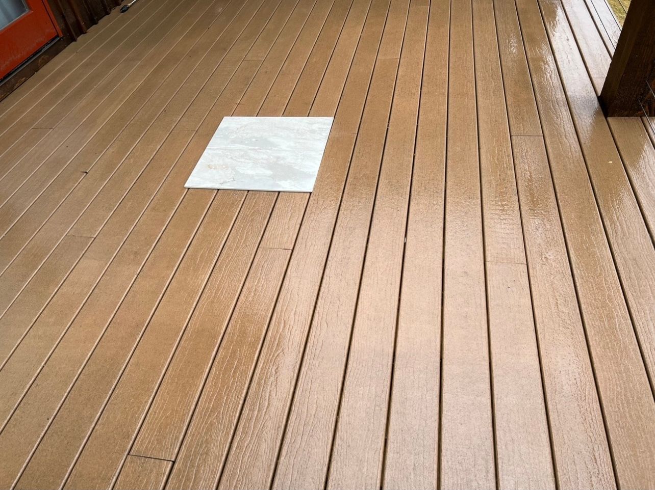 A piece of paper is sitting on a wooden deck.