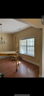 An empty dining room with a table and a window.