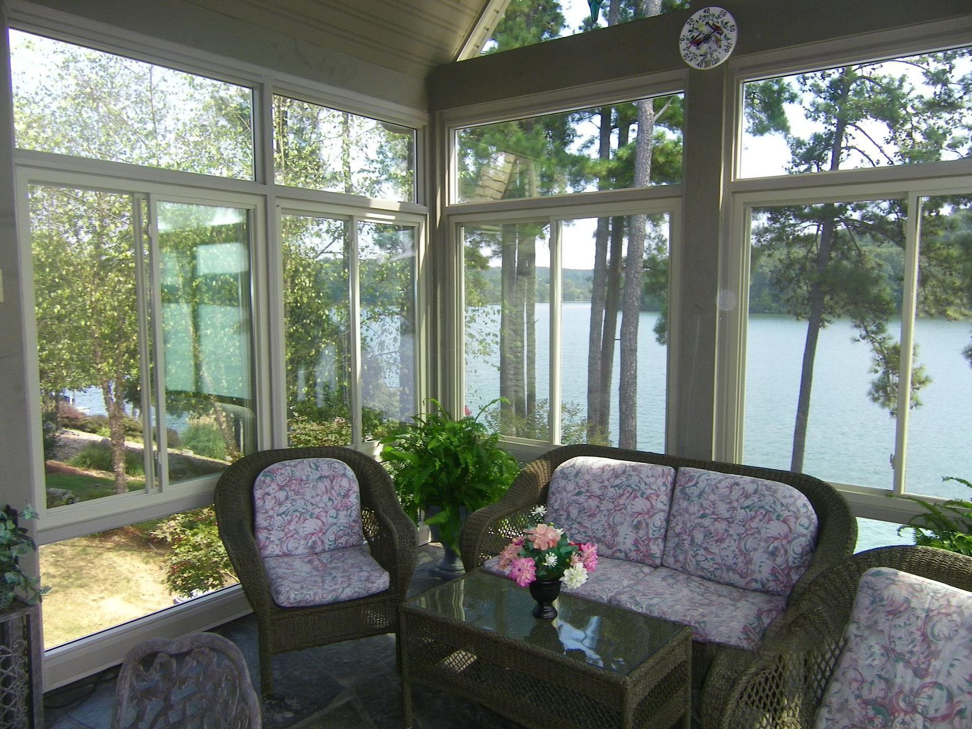 A screened in porch with a view of a lake