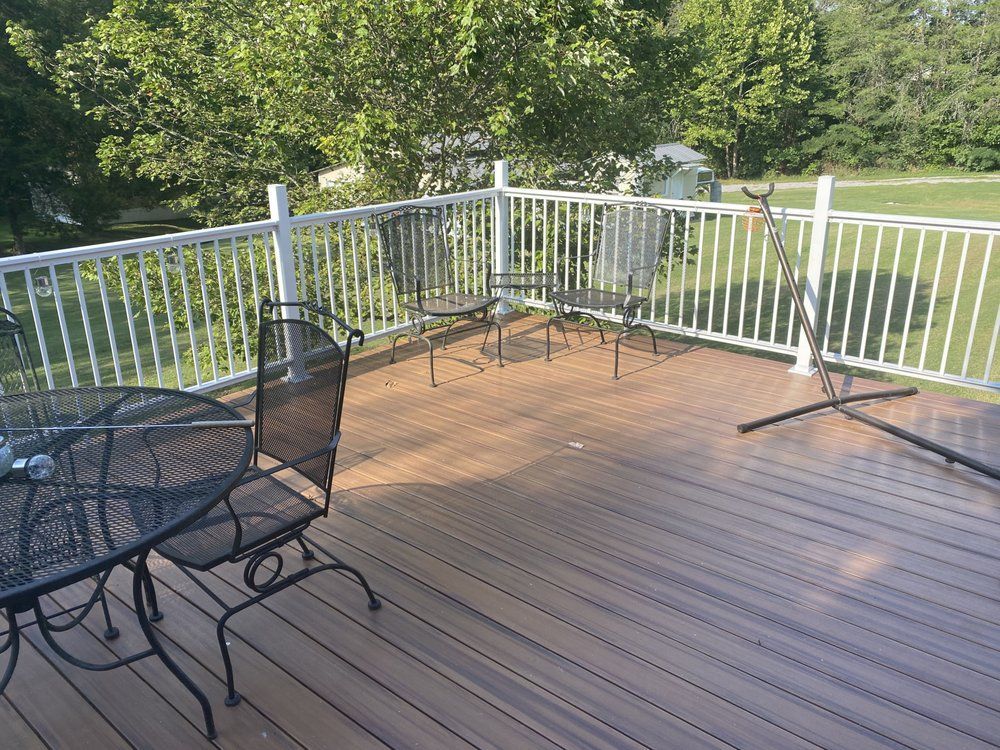 A wooden deck with a table and chairs on it.