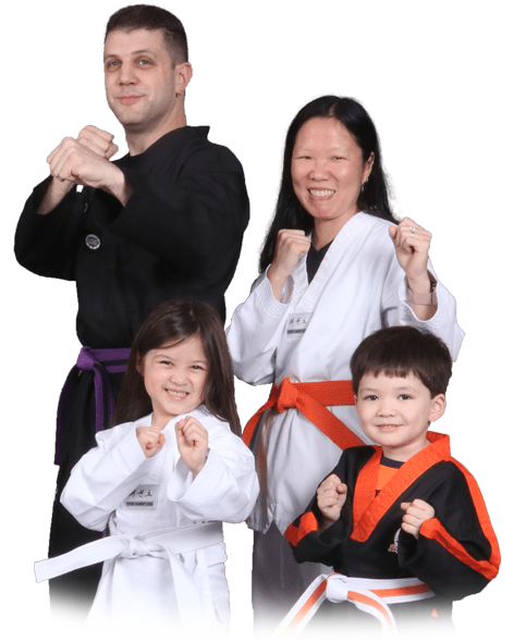 A family posing for a picture wearing martial arts uniforms