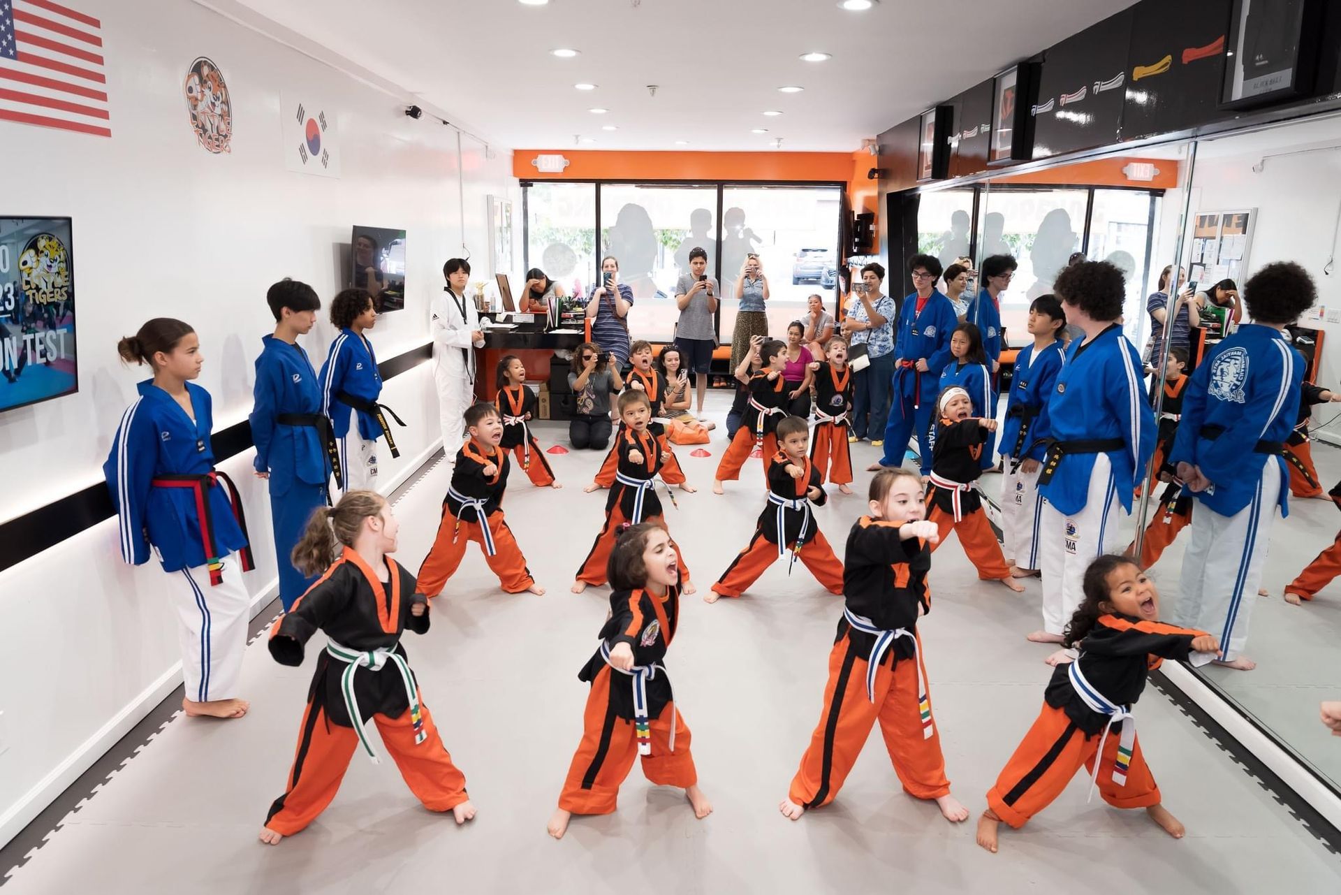 A girl in a taekwondo uniform has a black and red belt