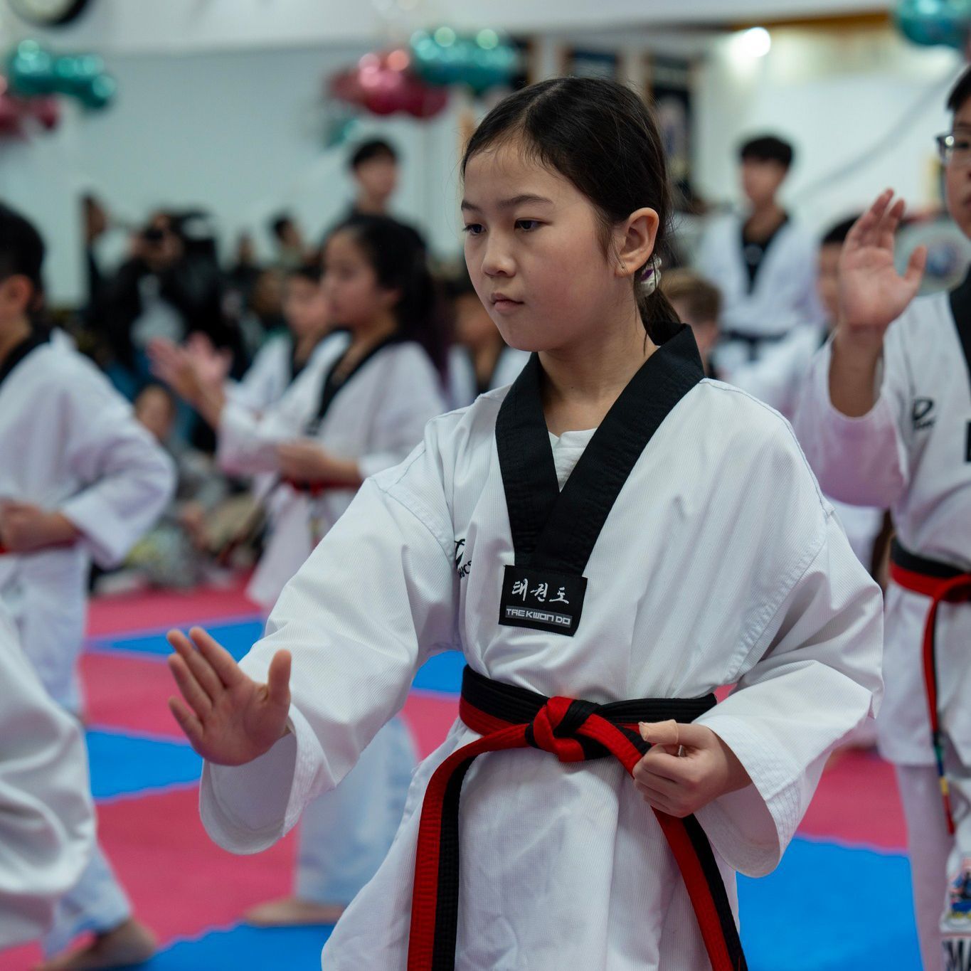 A man is teaching a young boy martial arts