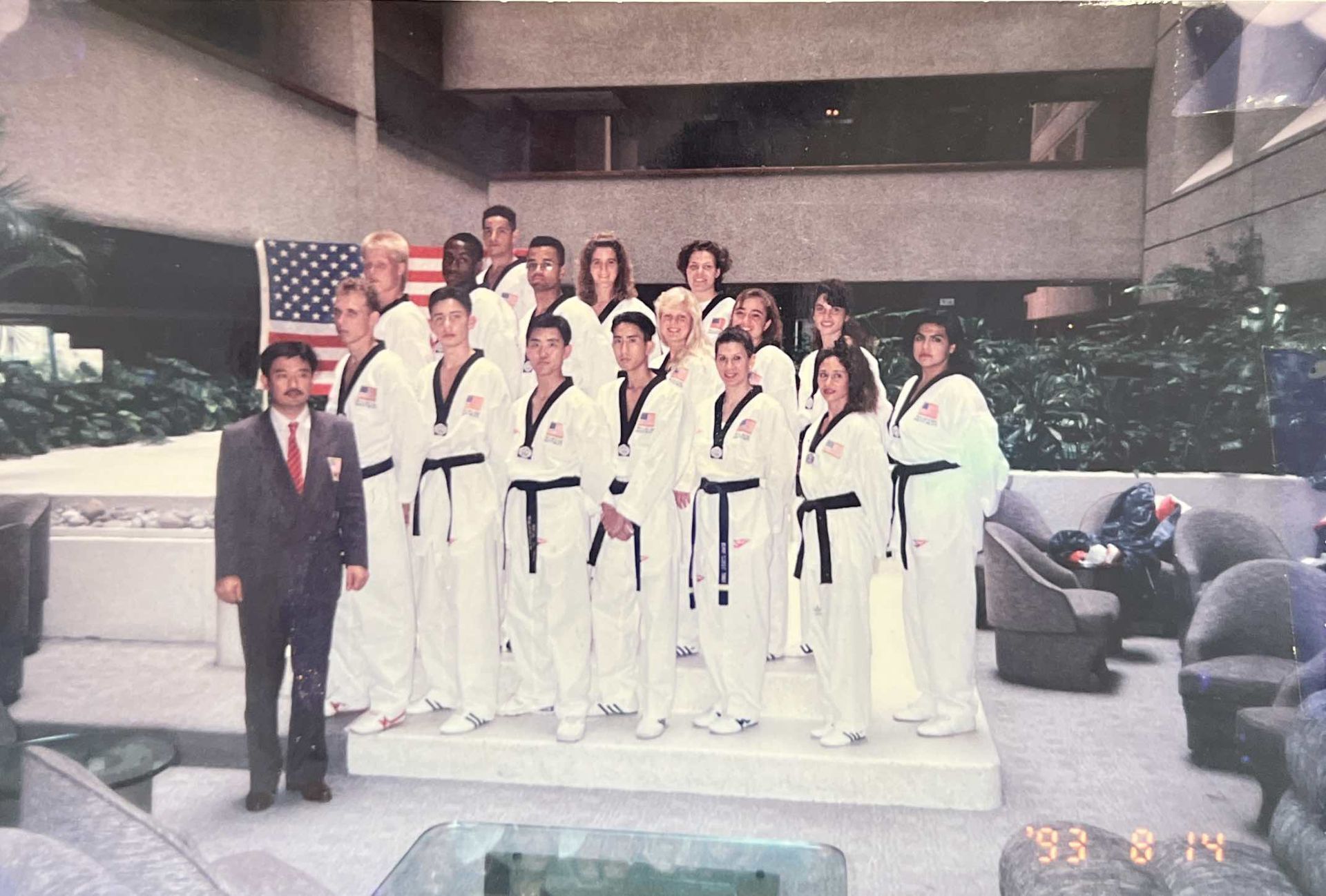 A group of people posing for a picture with the word taekwondo on their uniforms