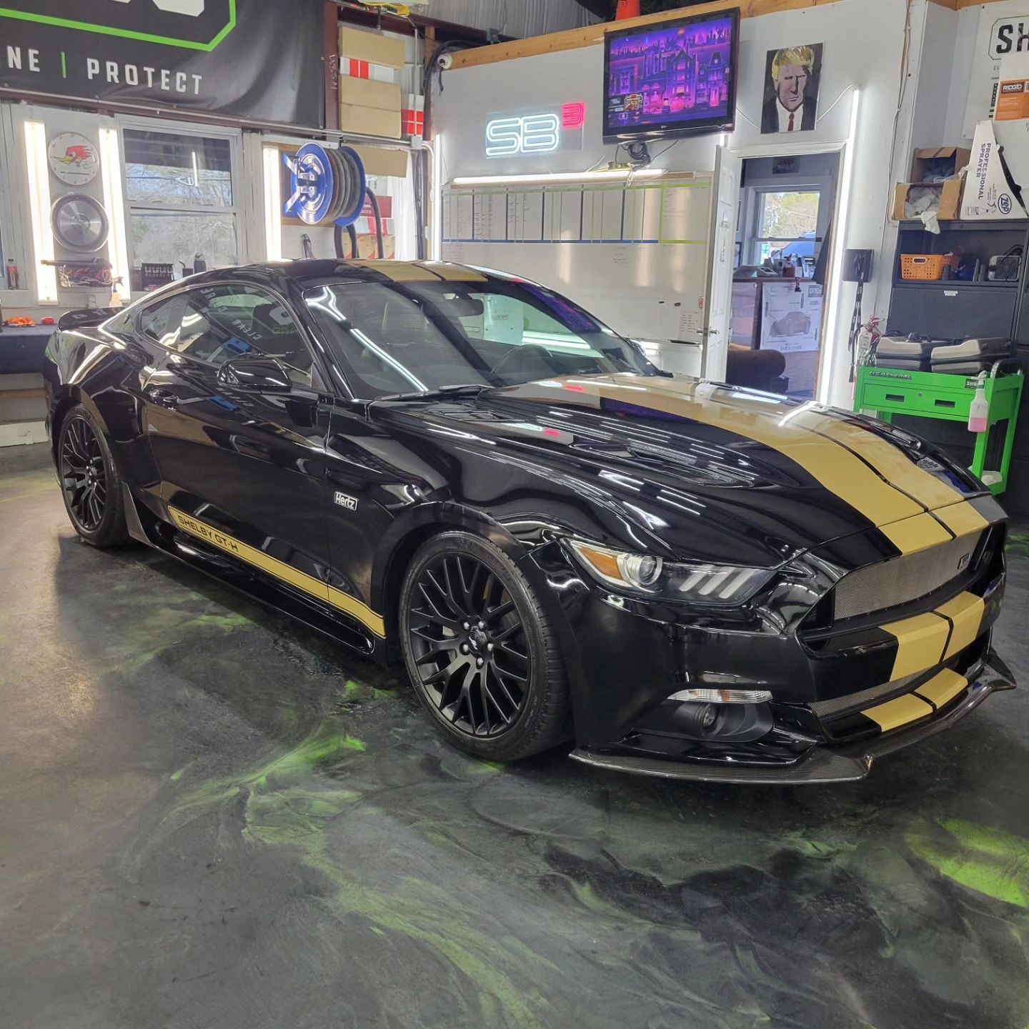 Black and gold Shelby Mustang with ceramic coating in detailing shop