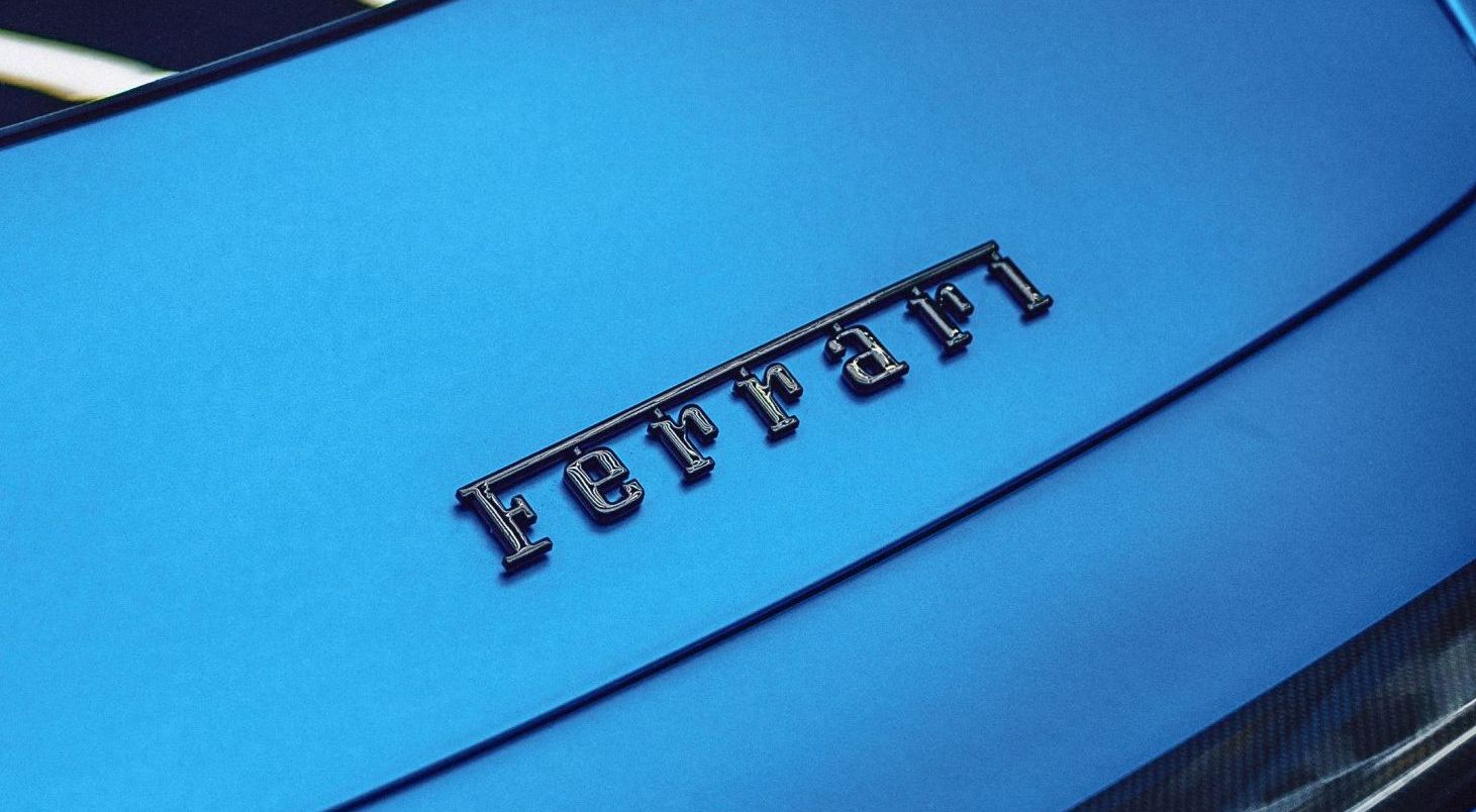 A close up of the ferrari logo on a blue car
