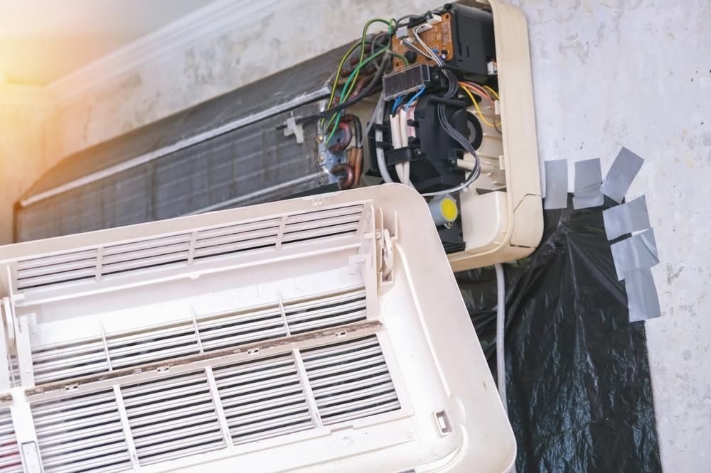 The Inside of An Air Conditioner Is Being Repaired — JDG Refrigeration & Air in Lennox Head, NSW