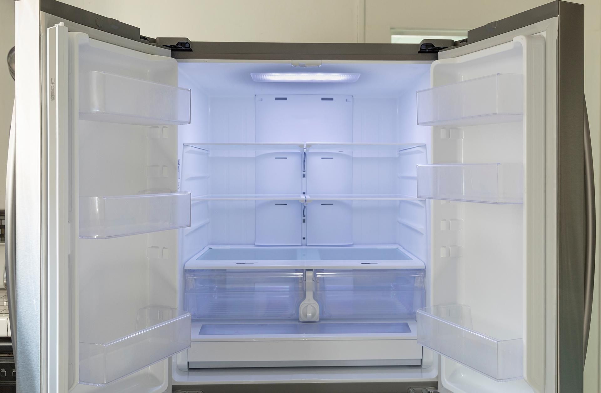 The Inside of An Empty Refrigerator with The Doors Open — JDG Refrigeration & Air in Goonellabah, NSW