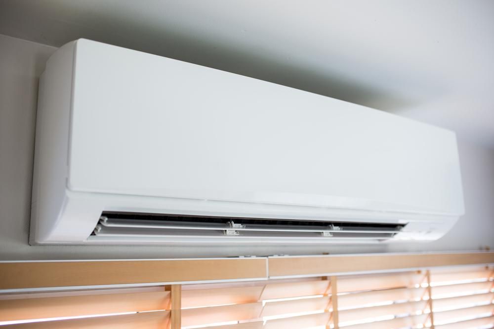 A White Air Conditioner Is Hanging from The Ceiling — JDG Refrigeration & Air in Goonellabah, NSW
