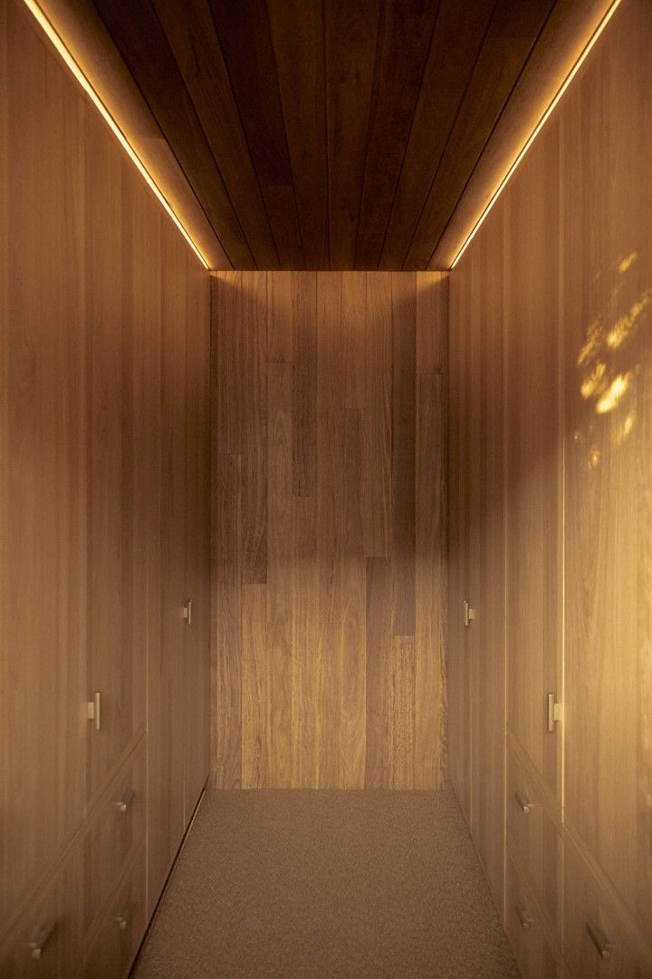 Wooden corridor with recessed lighting, vertical paneling, and a warm, inviting glow — BSpoke Cabinet Making & Joinery in Southerland Shire, NSW
