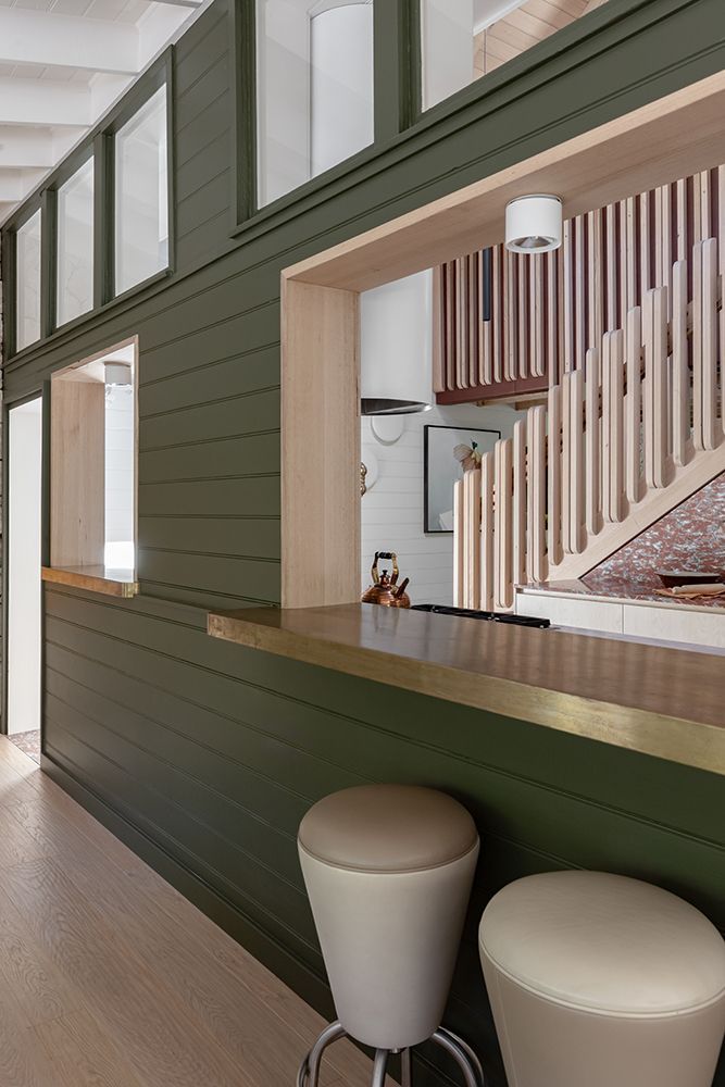 Green Panelled Bar Area with Brass Trim, Two Stools, and a View into a Stairwell — BSpoke Cabinet Making & Joinery in Unanderra, NSW