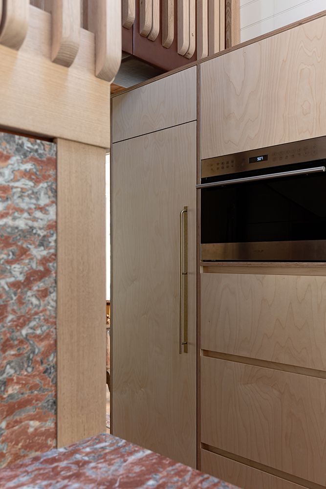 Kitchen with Light Timber Cabinetry and Marble Wall; Oven Visible — BSpoke Cabinet Making & Joinery in Unanderra, NSW