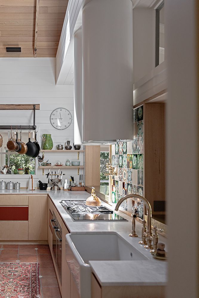 Kitchen with Light Timber Cabinetry, White Sink, Gas Cooktop, and Gold Tapware — BSpoke Cabinet Making & Joinery in Unanderra, NSW
