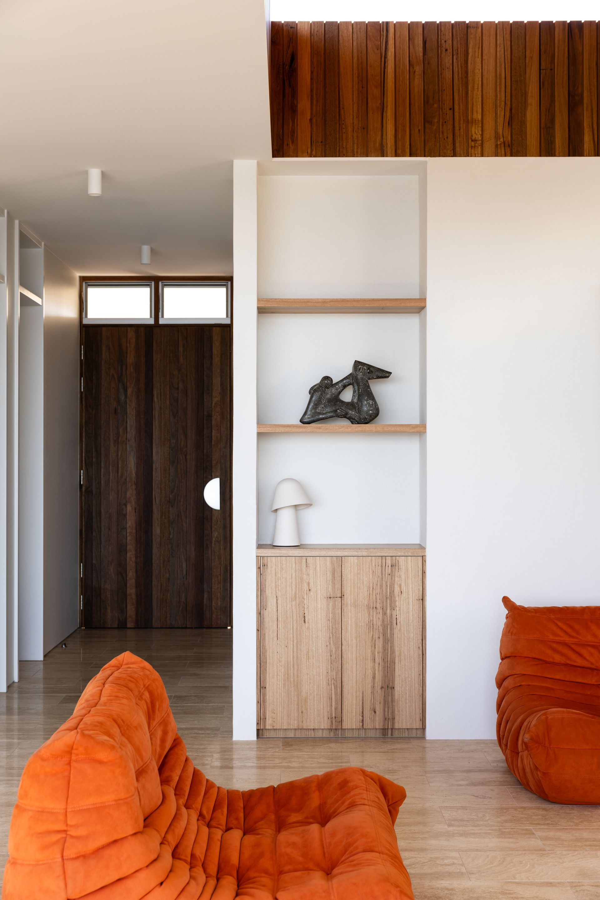 Lounge with Wooden Features and Orange Couches — BSpoke Cabinet Making & Joinery in Unanderra, NSW