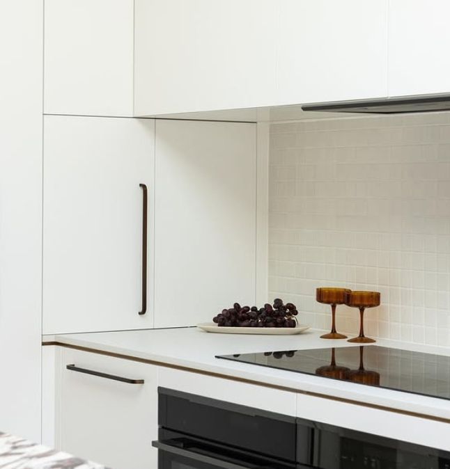 White Modern Kitchen With Black Oven, Countertops — BSpoke Cabinet Making & Joinery in Unanderra, NSW