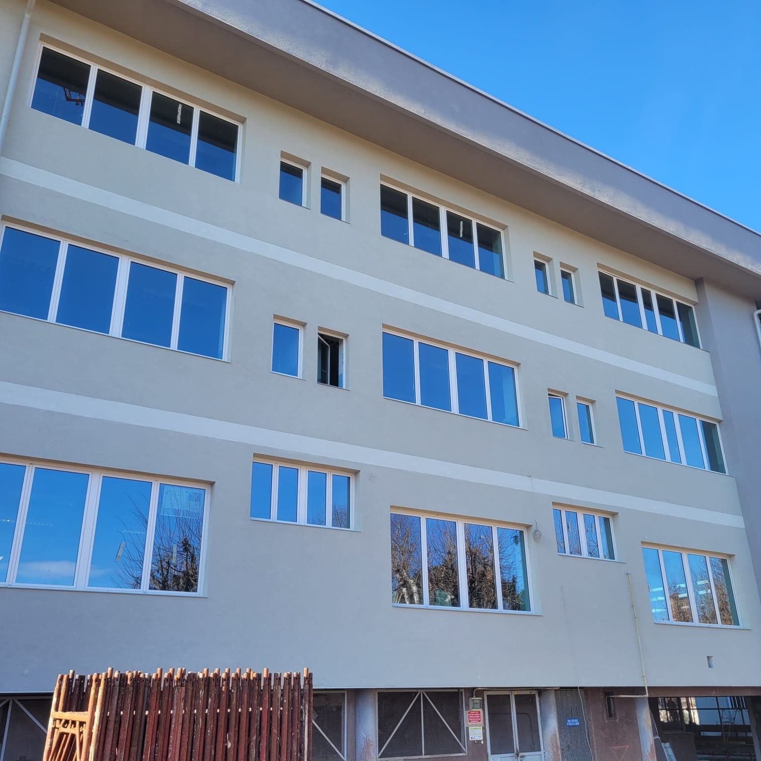 Un grande edificio con molte finestre e un cielo azzurro sullo sfondo