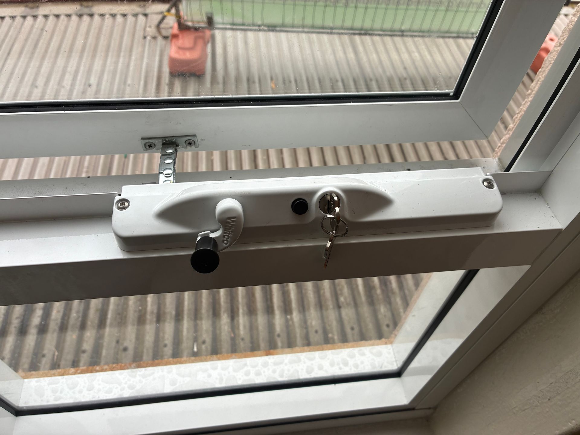 White window handle and lock on a window overlooking a corrugated roof outside — Kracken Windows and Doors In Terrey Hills, NSW