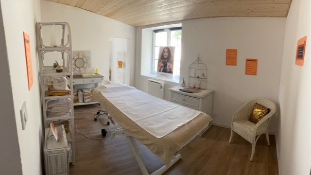 Une salle avec une table de massage et une chaise.