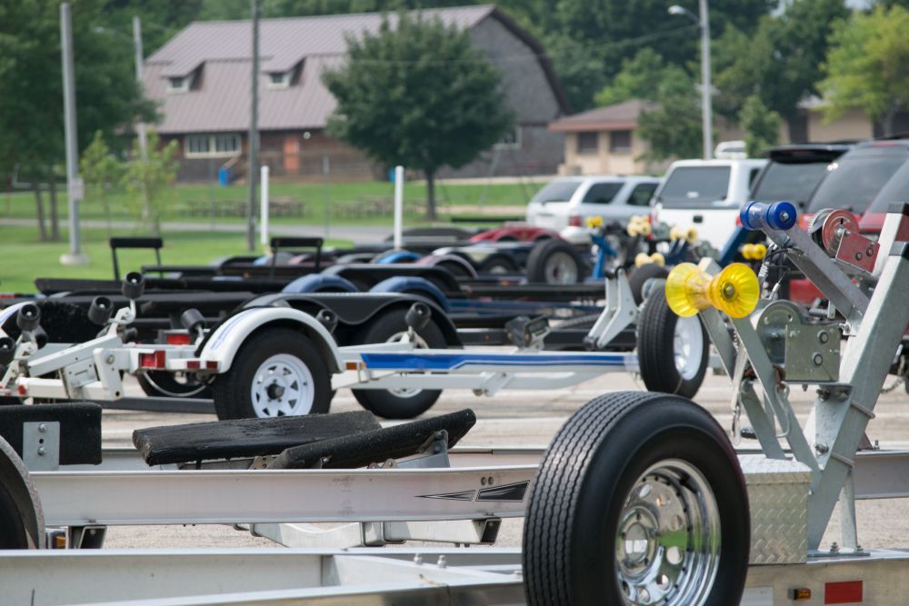 Line of Boat Trailers in a Parking Lot — Boat Service in Woodburn, NSW