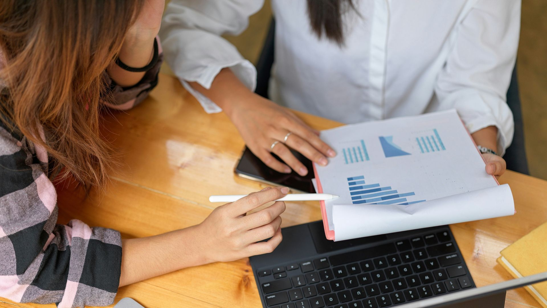 A man with a backpack is standing next to a lake in the woods.