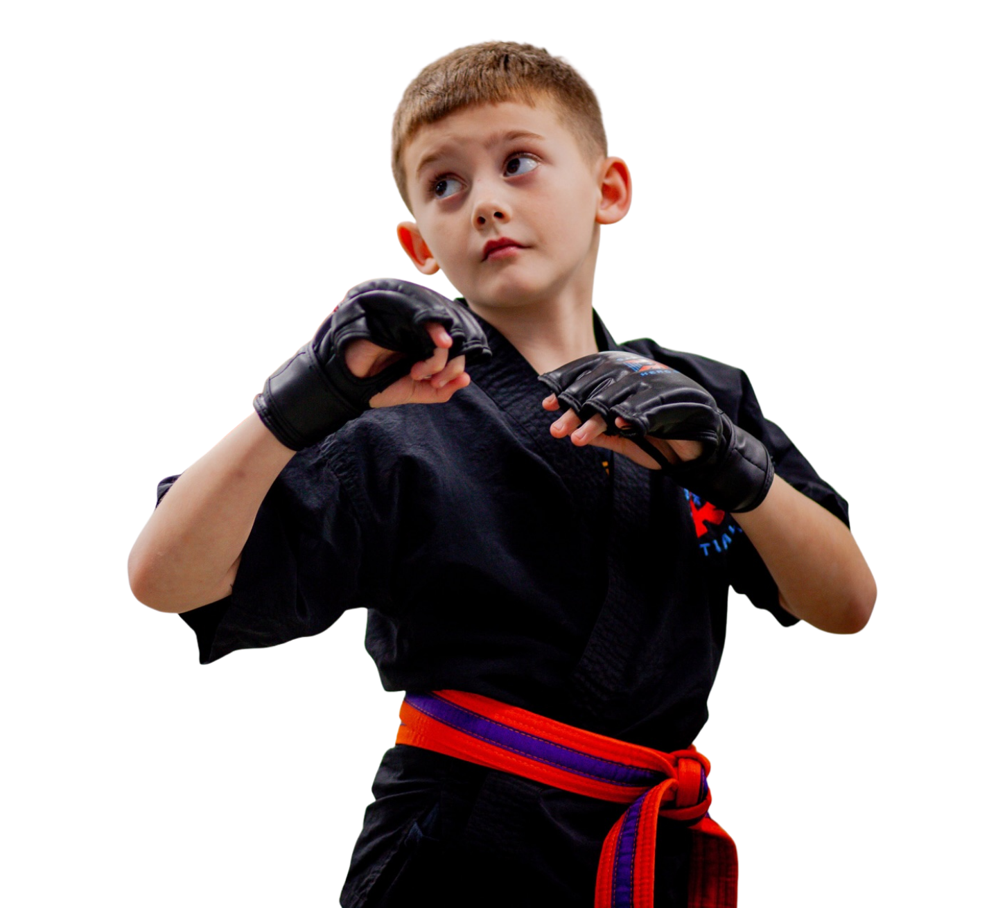A boy and two girls in karate uniforms are pointing at the camera