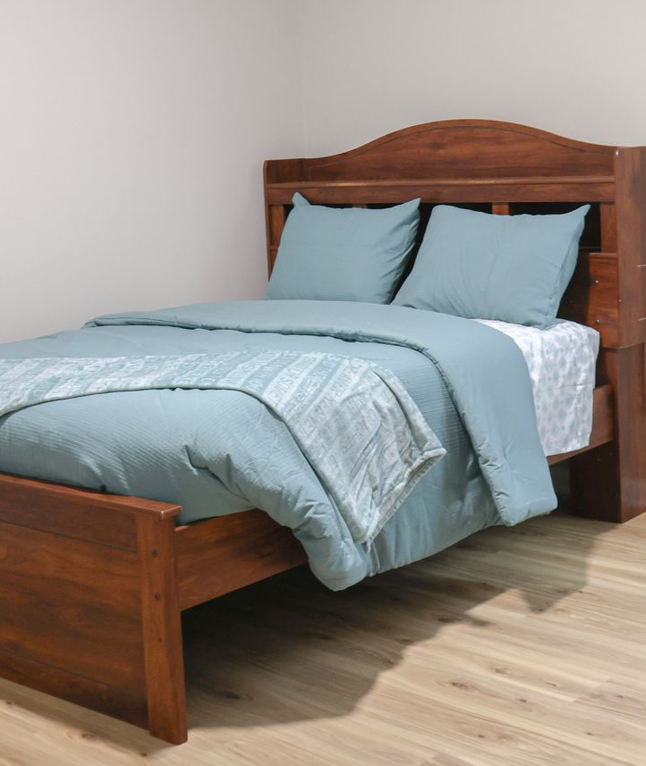 Clean and comfortable private bedroom for residential youth support.