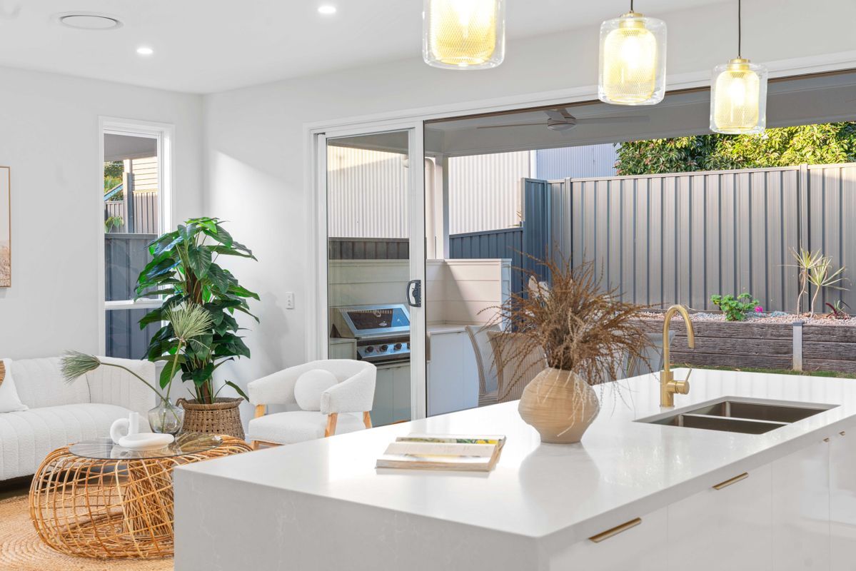 A kitchen with a large island and a sliding glass door leading to a patio.