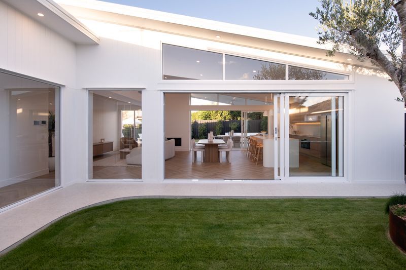 A white house with a large sliding glass door