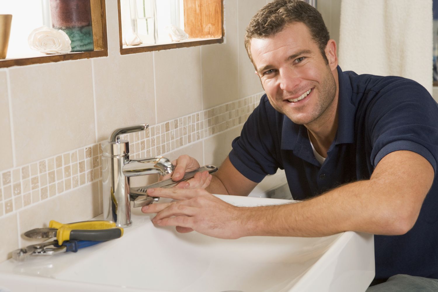 Plumber carrying out plumbing maintenance work in Queenstown