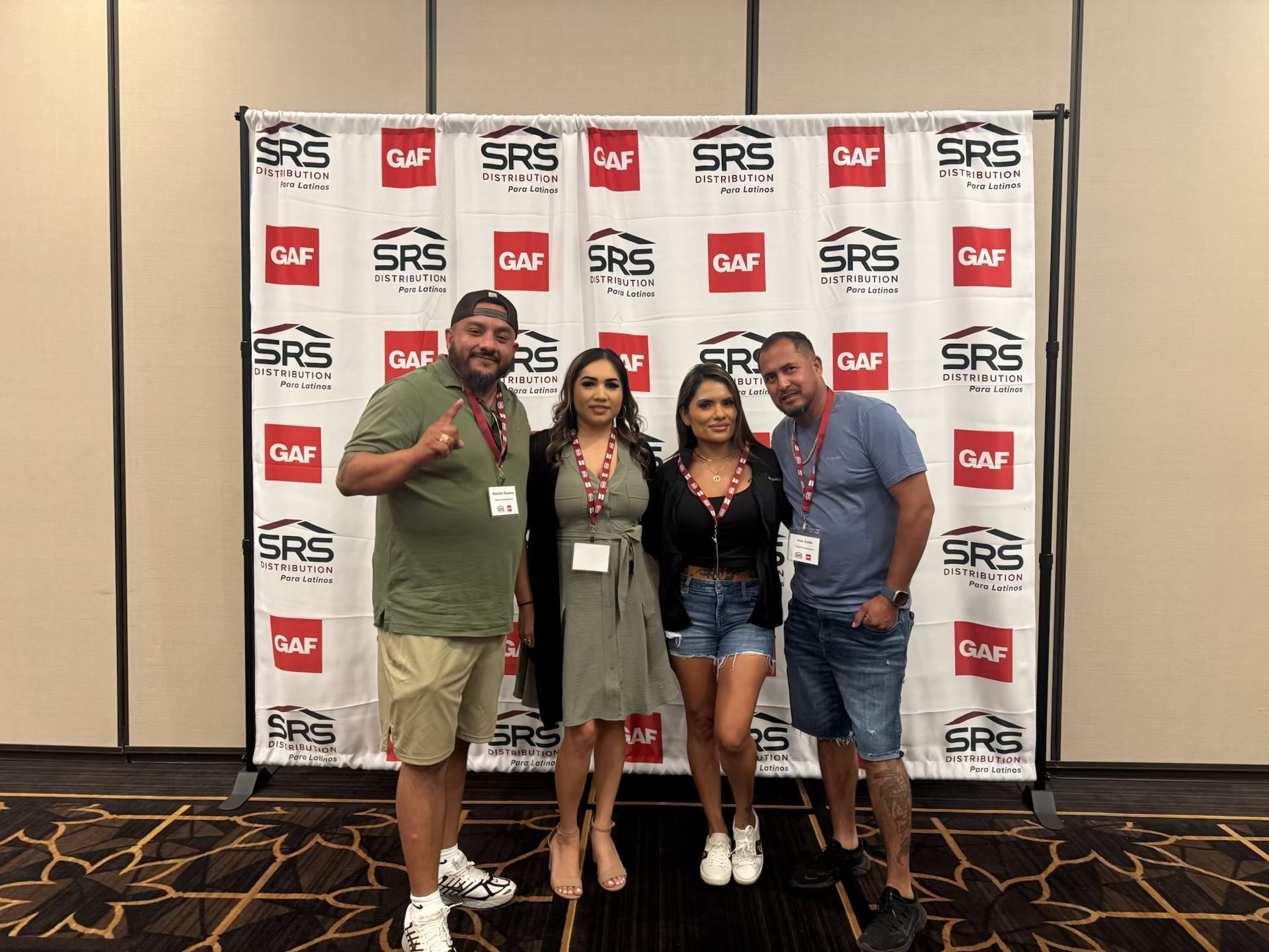 Tan house with gray roof against a blue sky, multiple windows, and a radio antenna.