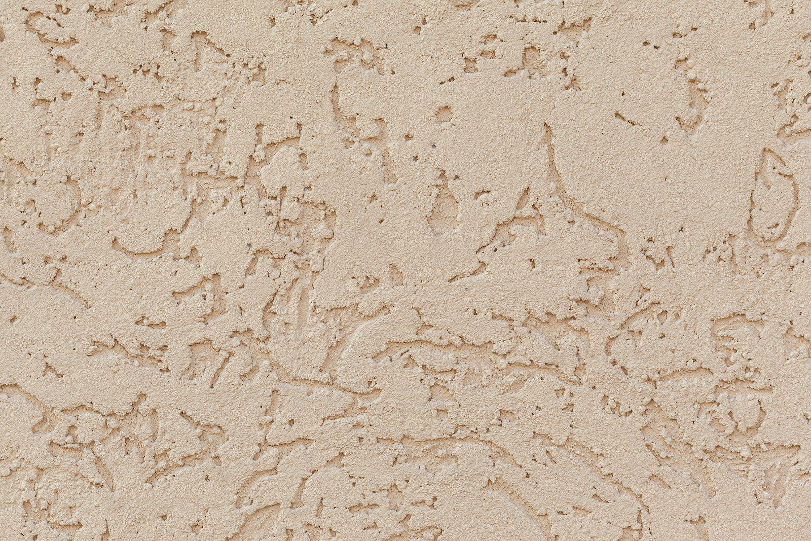 Beige stucco wall with a textured, scratch-coat finish.