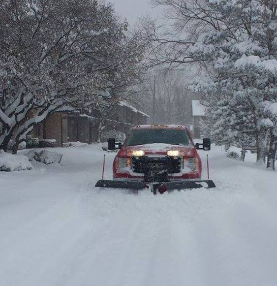 Red truck plowing snow
