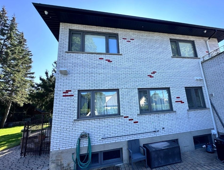 A large white brick house with a lot of windows