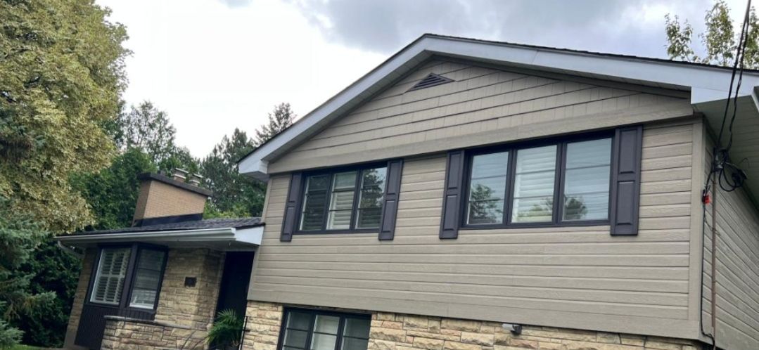 A large house with a lot of windows and shutters on it.