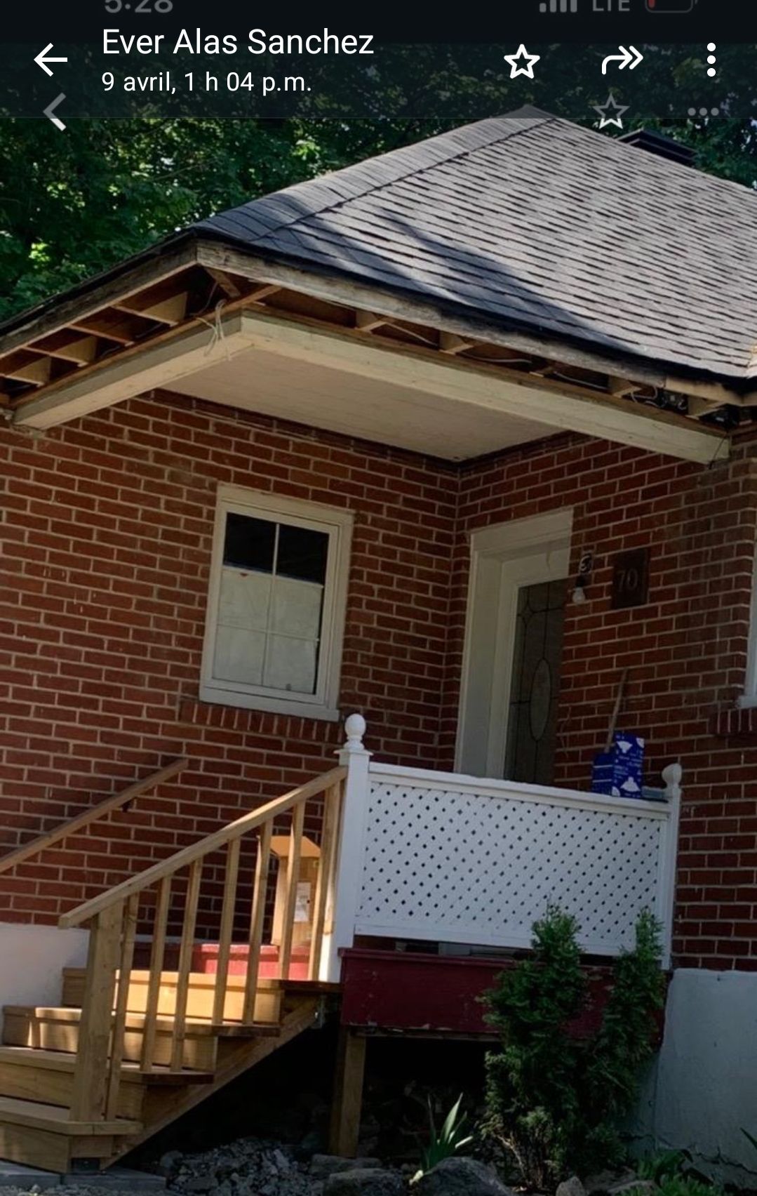 A brick house with a porch and stairs
