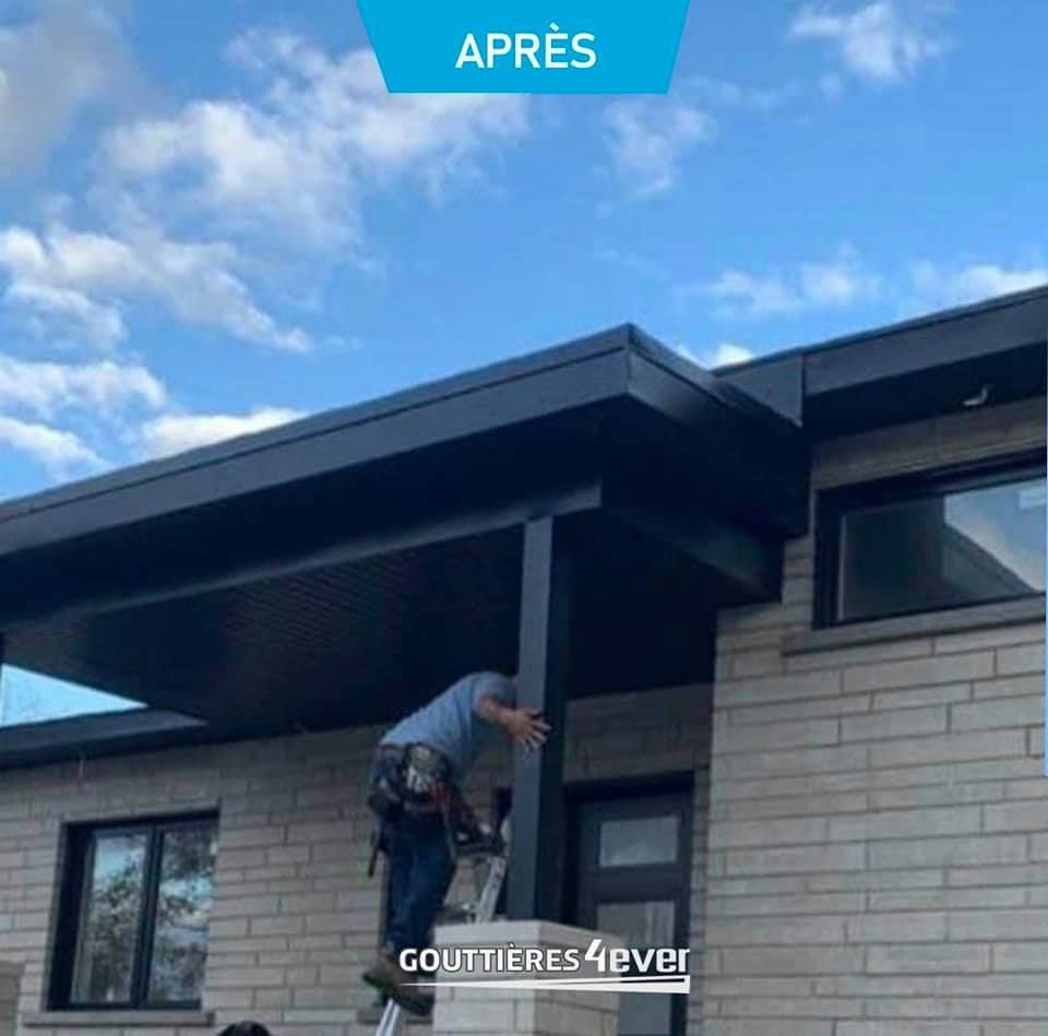 A man is standing on a ladder in front of a brick house.