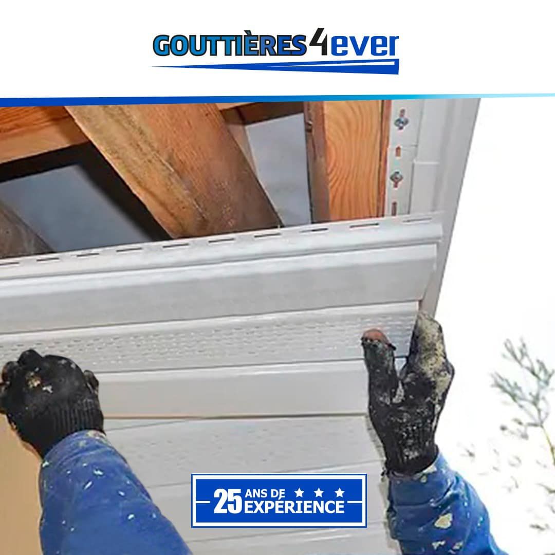 A person wearing black gloves is holding a piece of siding.