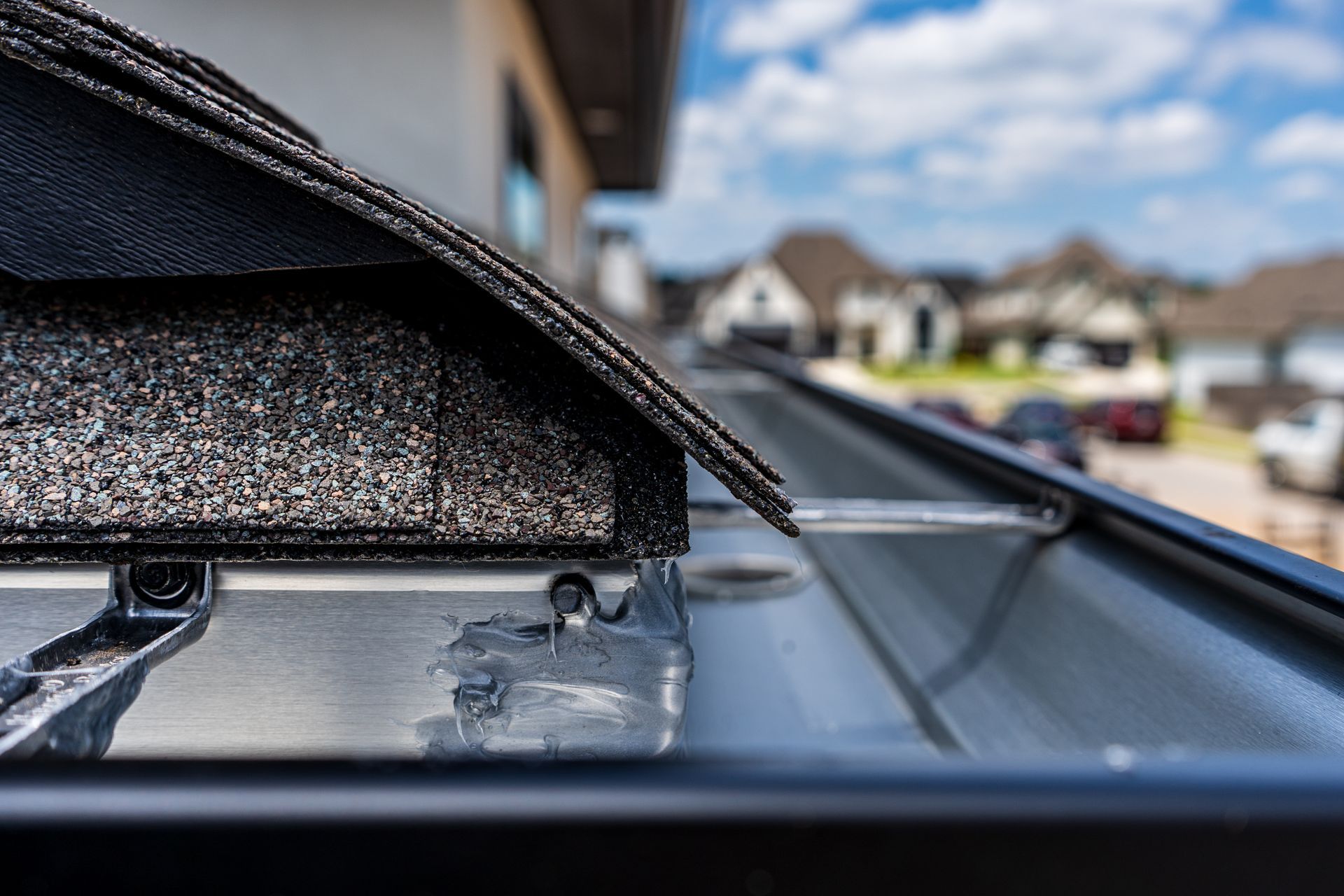 A close up of a roof with a gutter attached to it.