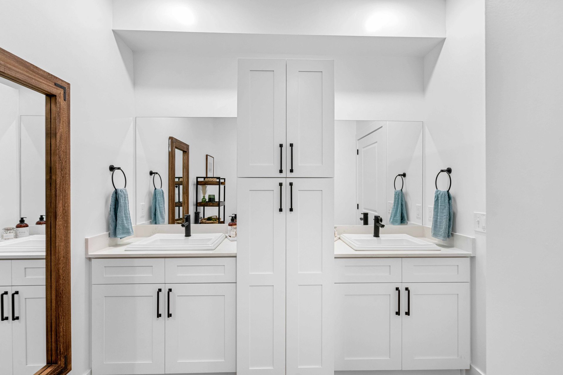 Apartment bathroom with two sinks and a large mirror.