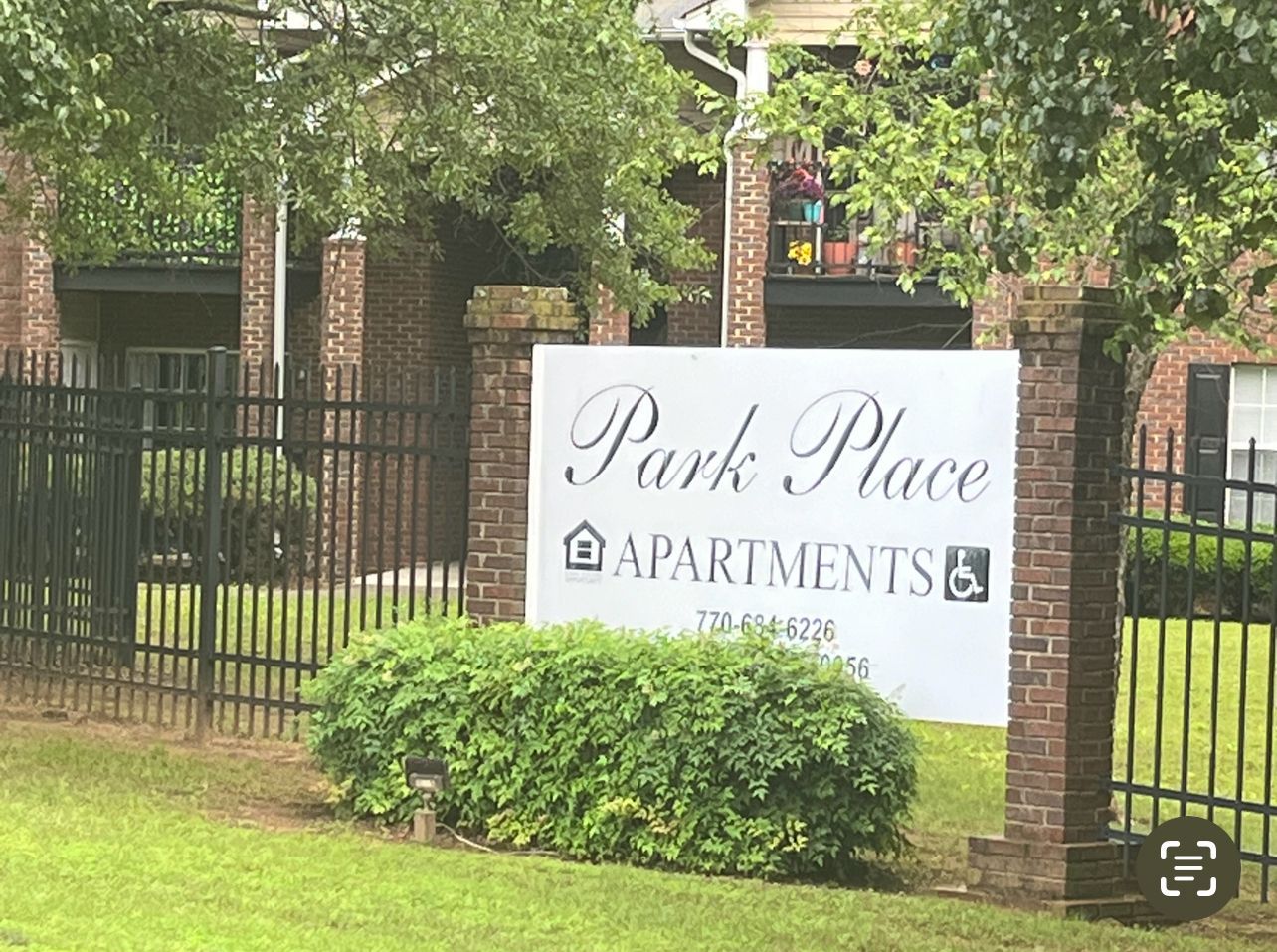 Group of people gathered around each other holding drinks and chatting.