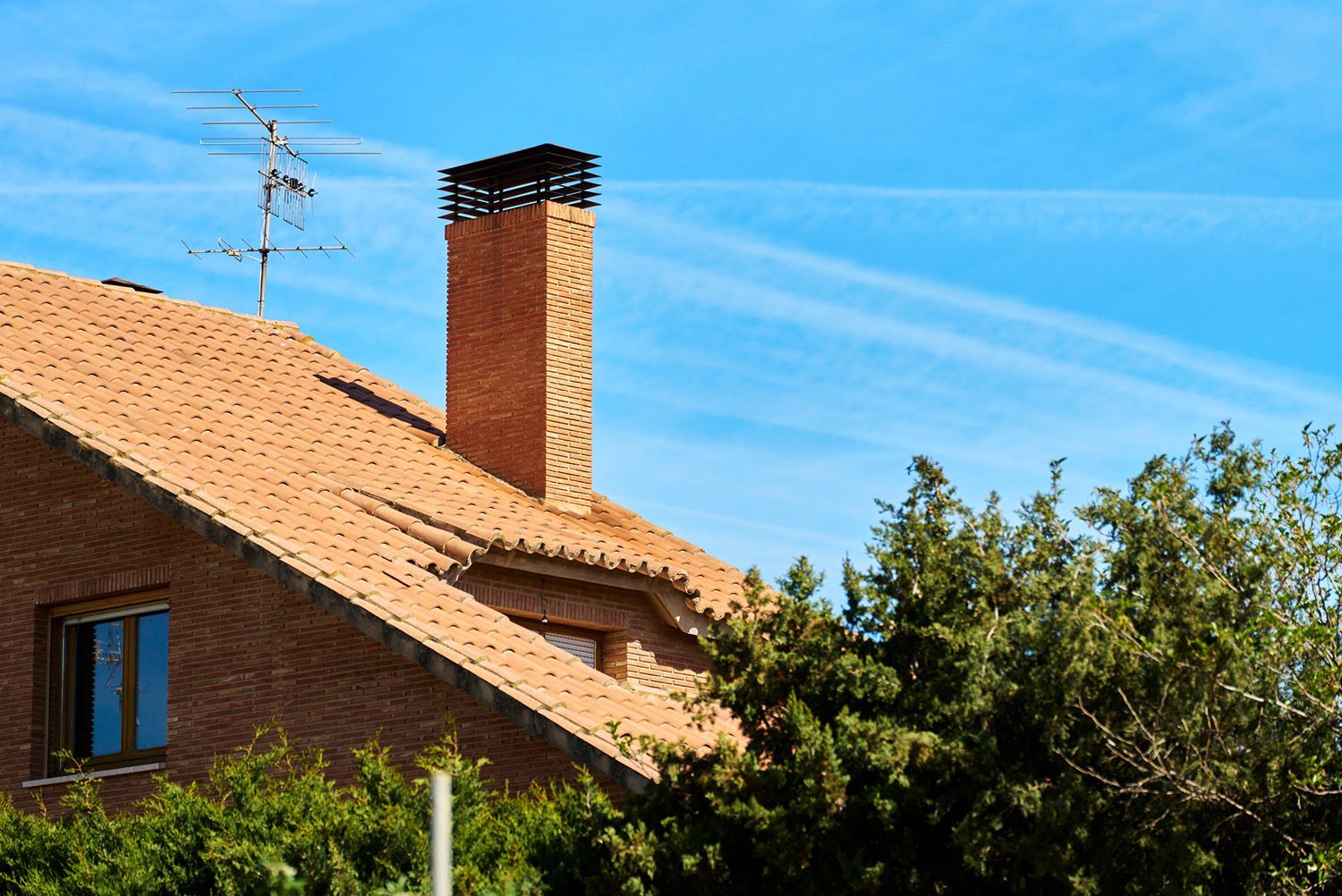 A brick house with a chimney on the roof