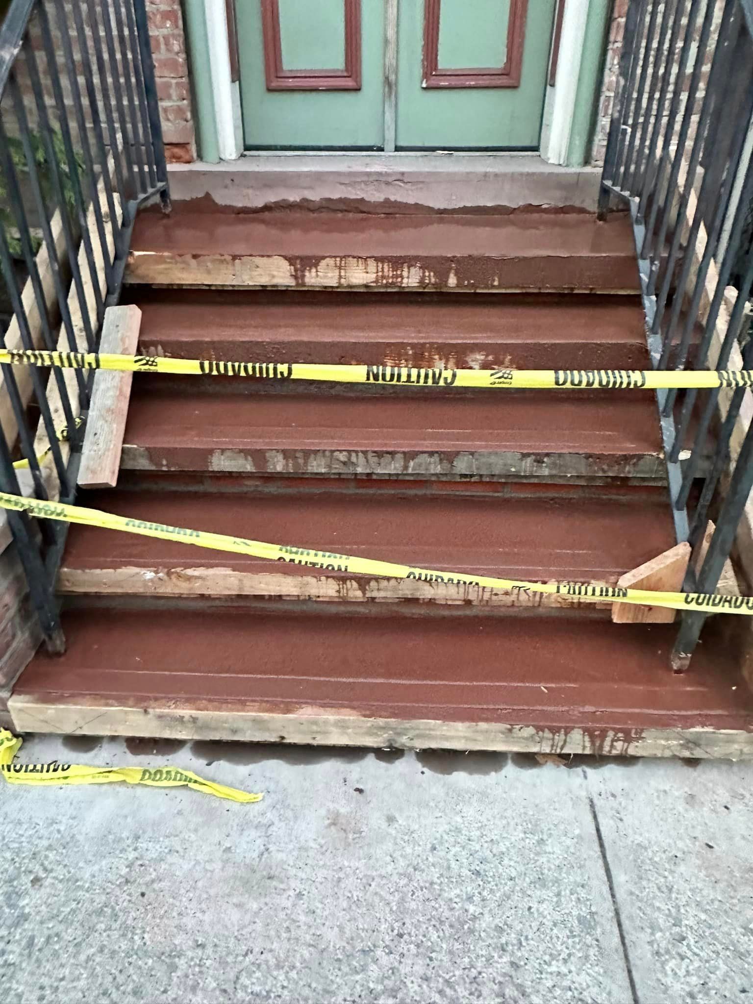 A set of stairs with a yellow tape around them.