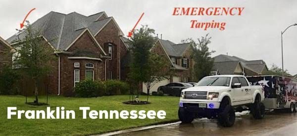 A white truck parked in front of a brick house in Franklin, Tennessee, highlighting emergency roof tarping services.