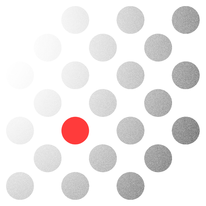 Office interior with several people working at computers; a wall with green plants and a company sign is visible.