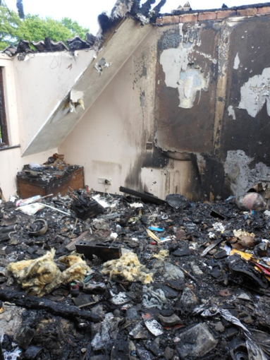 Fire-destroyed upper storey followed by complete rebuild