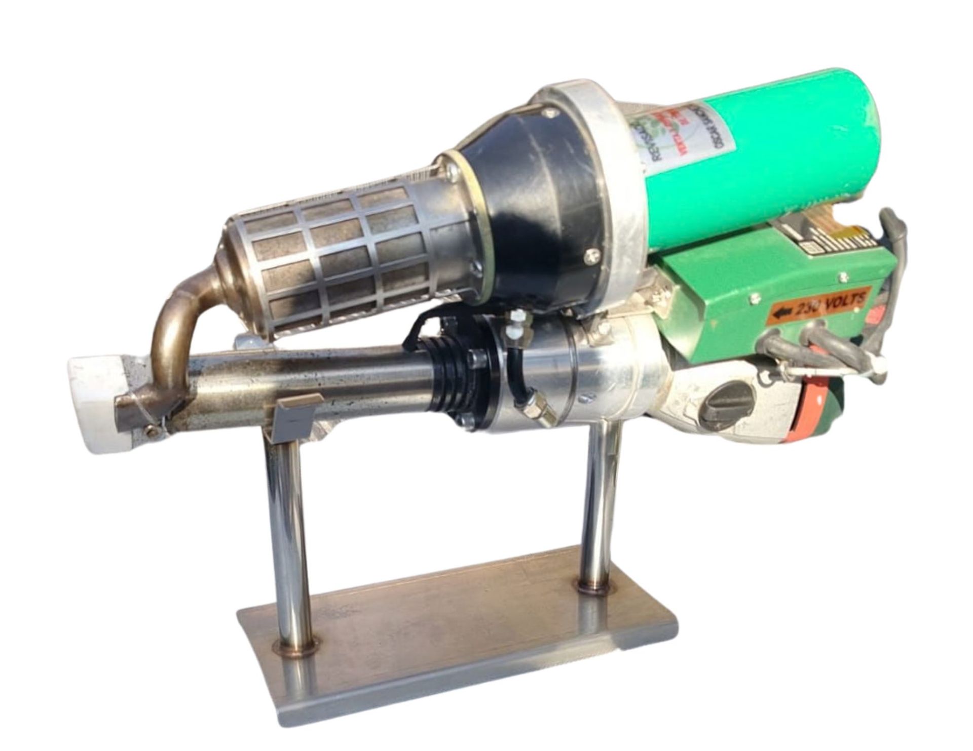 A green and black handheld plastic welder on a metal stand.